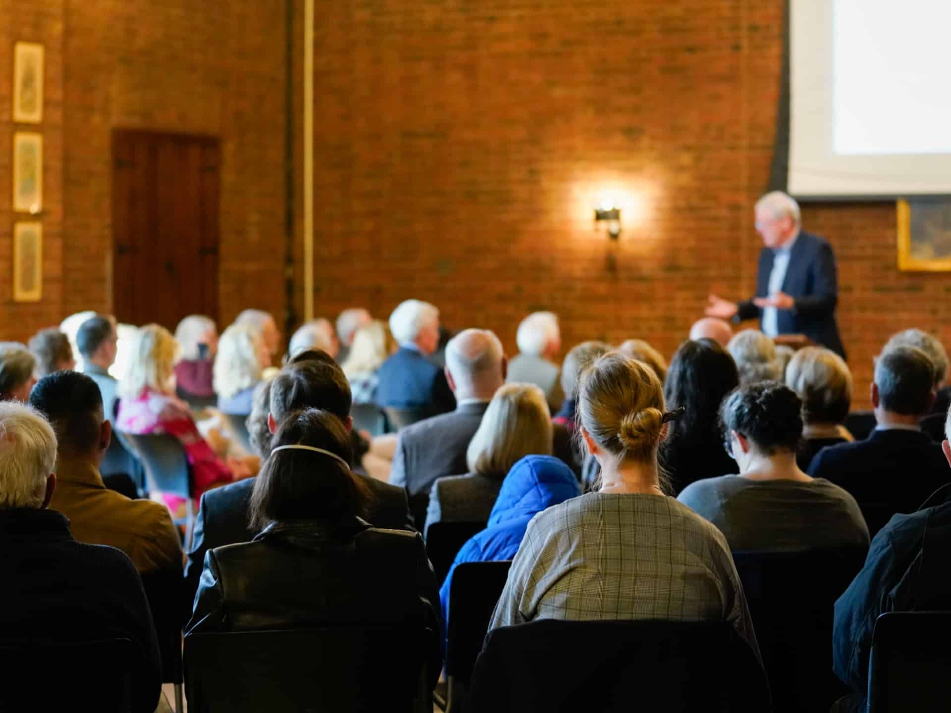 Adults seated together listening to a speaker during a formation or educational program at St. John’s Cathedral in Denver.