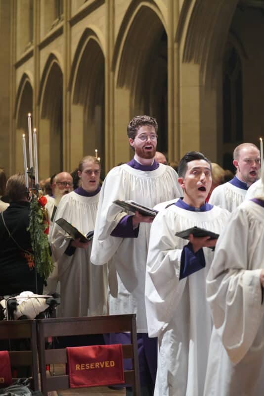 Members of the St. John’s Cathedral choir sing in procession during a sacred music performance in the cathedral nave in Denver.