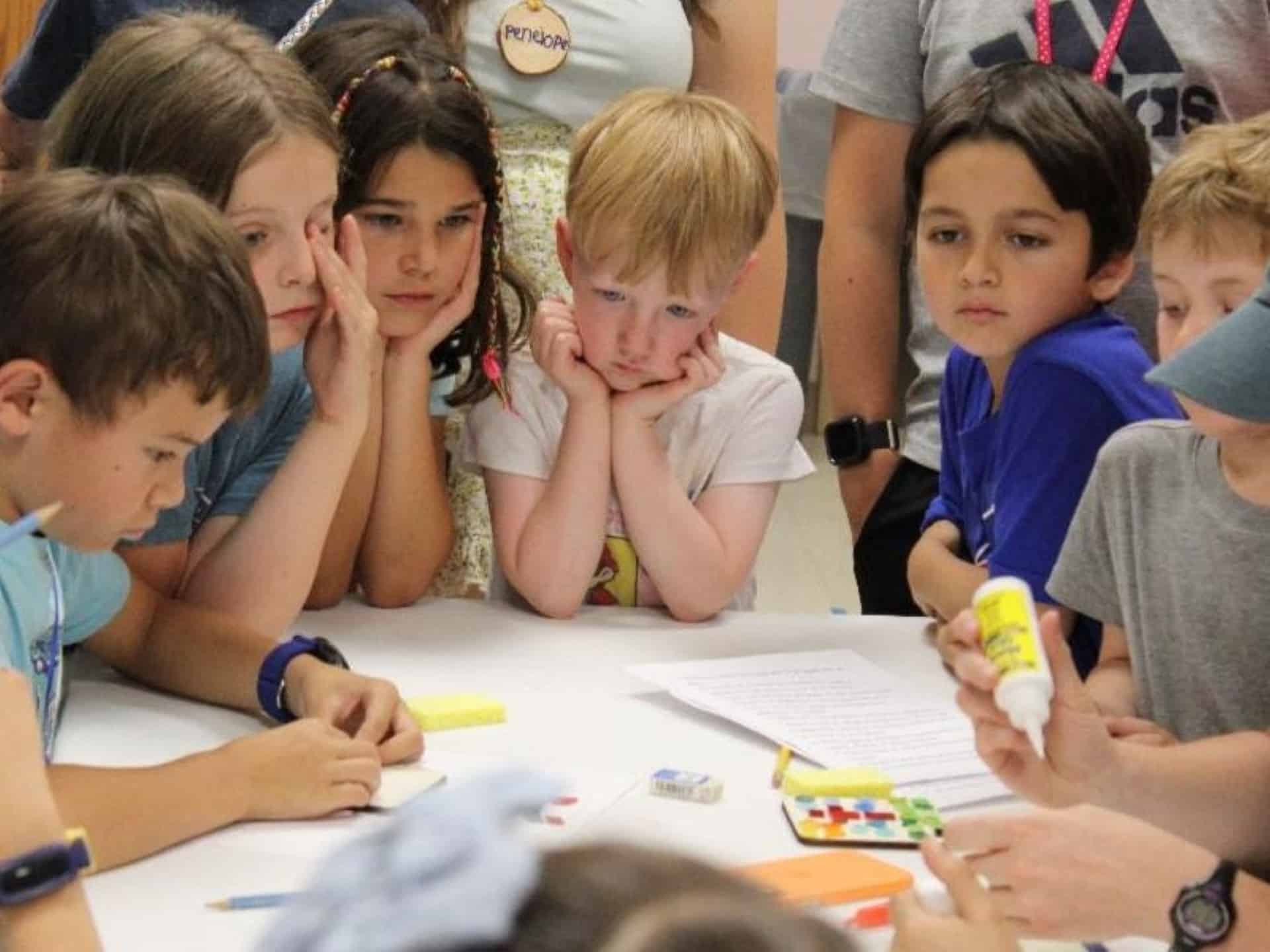 Children gathered around a table for a hands-on learning activity at St. John’s Cathedral in Denver.