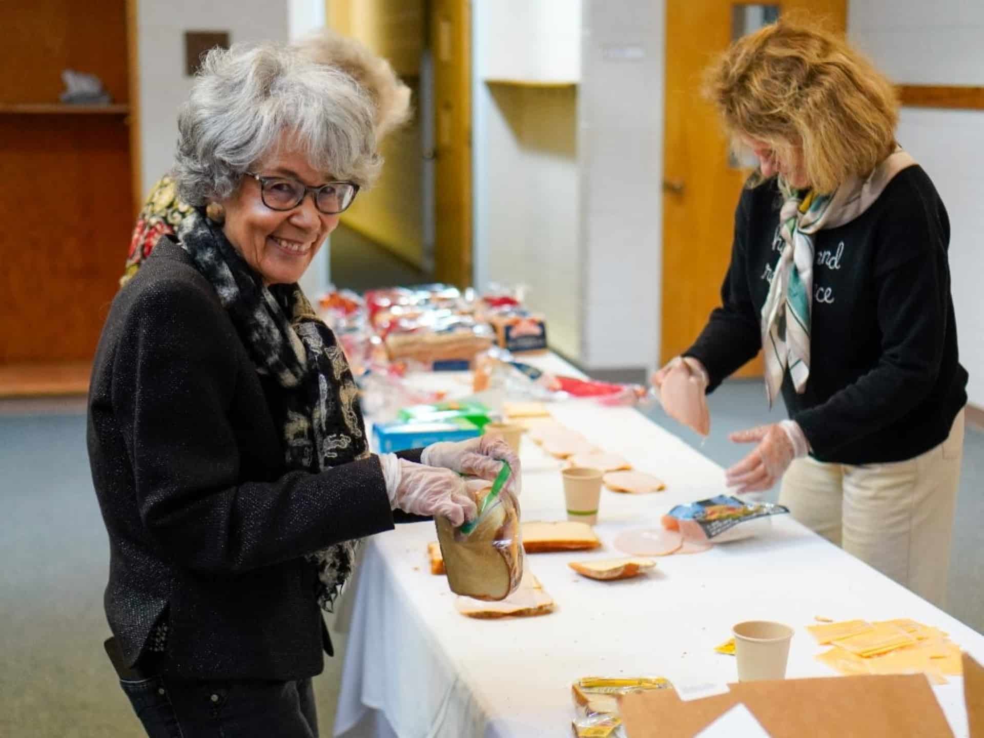 Volunteers preparing sandwiches together as part of a community service or outreach activity at St. John’s Cathedral in Denver.