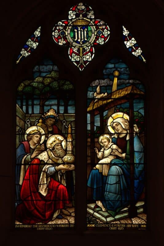 Stained glass window at St. John’s Cathedral in Denver depicting the Magi presenting gifts to Mary and the Christ child beneath the Star of Bethlehem.